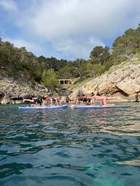 Sup Yoga Ibiza Relaxing Things To Do Rotated SUP yoga session on calm water in Ibiza